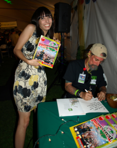 Vivian McPeak signing a copy of his new book Protestival for Princess of Pot Jodie Emery.